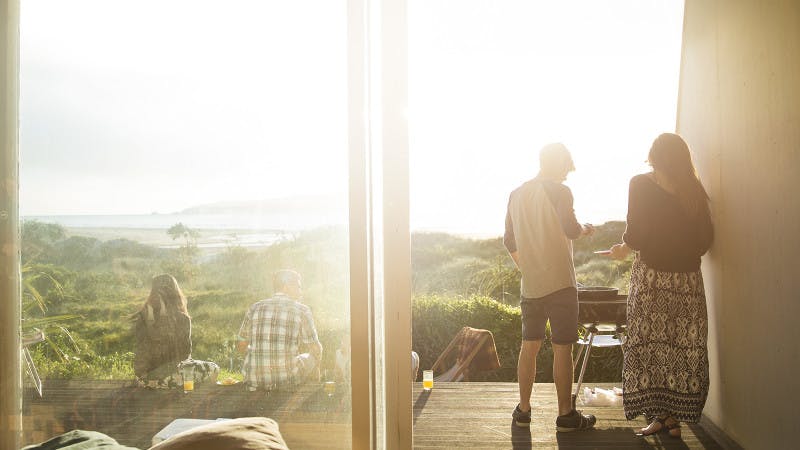Students relaxing in the sun at a bach (beach house)