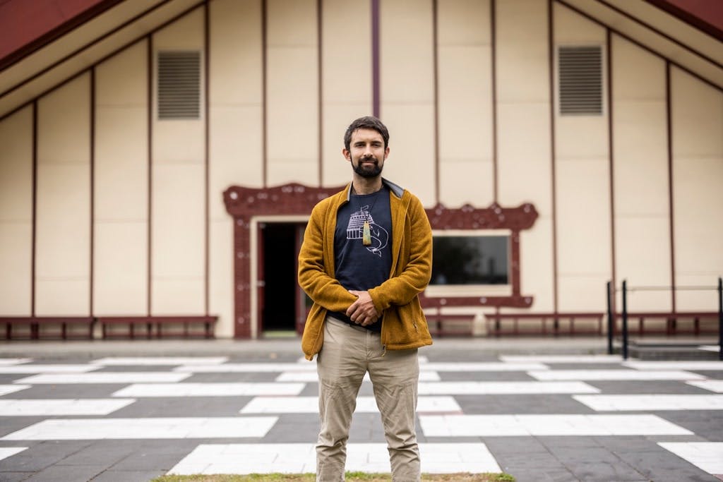 Man standing in front of a marae