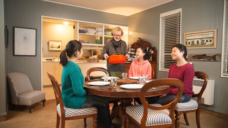 International students at the dinner table at their homestay accommodation